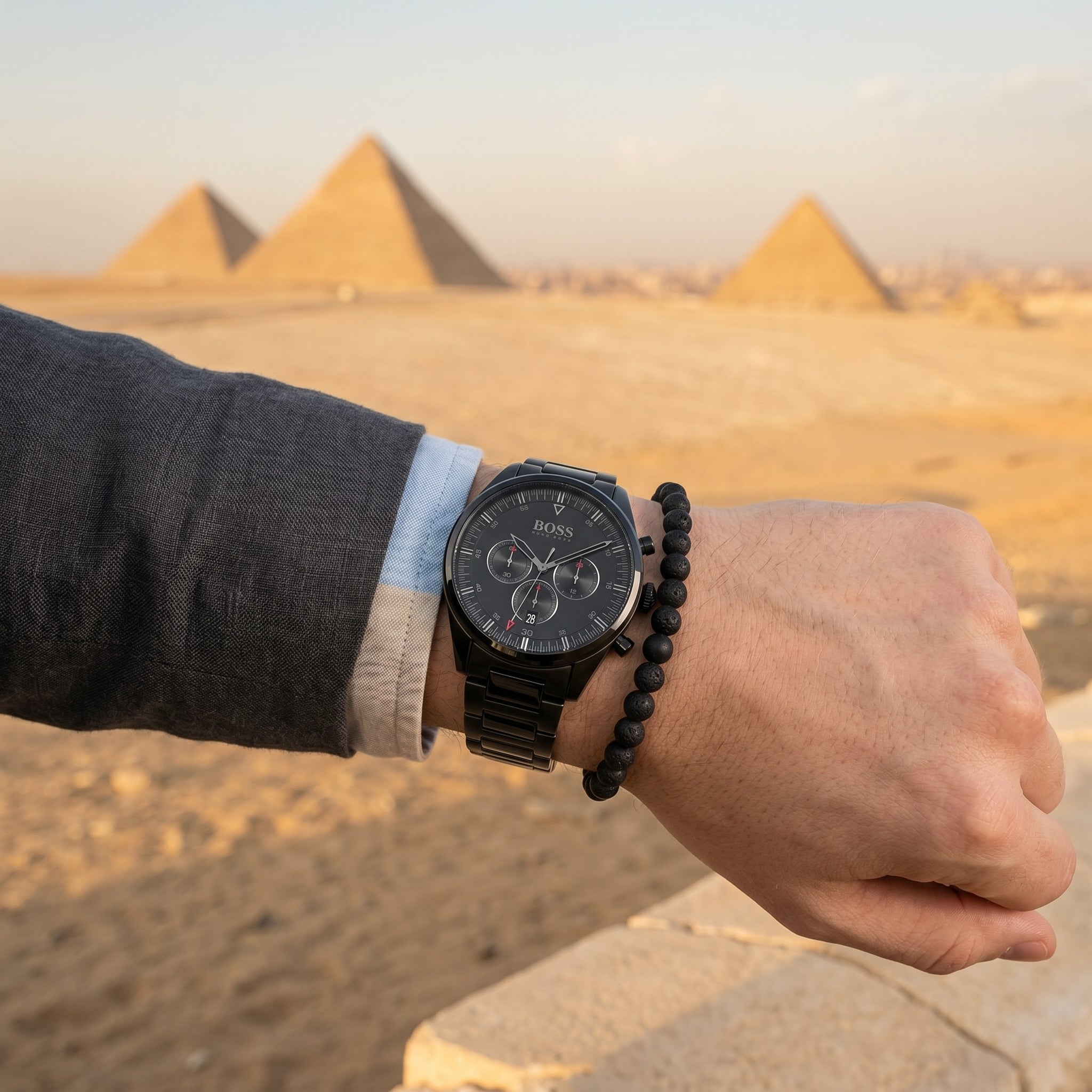 Raw lifestyle photo of Boss Pioneer 1513714 paired with business attire showing actual black finish from Luxury Hub Store.