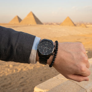 Raw lifestyle photo of Boss Pioneer 1513714 paired with business attire showing actual black finish from Luxury Hub Store.
