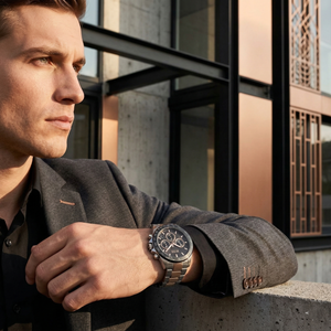 Professional man wearing Hugo Boss Hero 1513757 with black dial and silver rose gold metal strap water resistant 50m