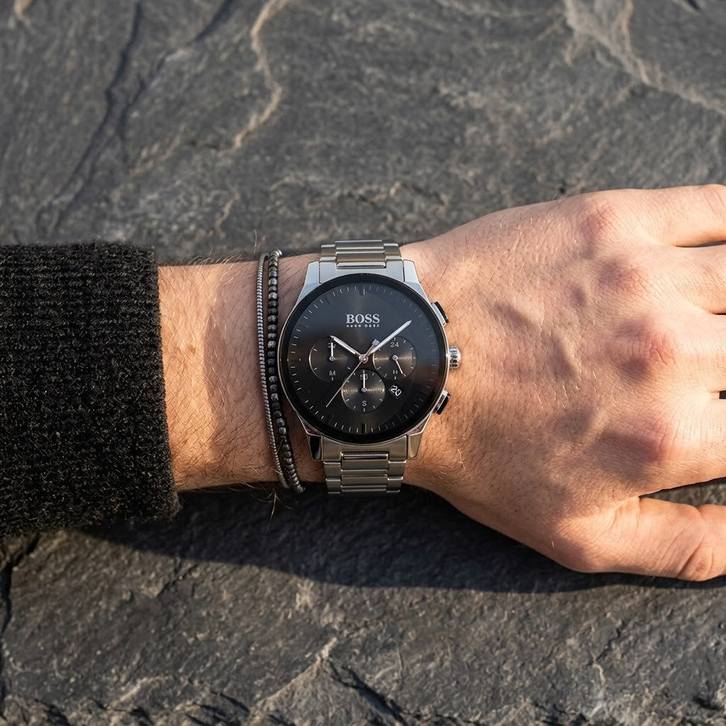 Close up of Hugo Boss Peak 1513762 men's quartz battery watch on wrist showing deep Black dial and luxury silver markers