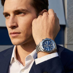 Professional man wearing Hugo Boss Vela 1513775 with blue dial and silver metal link strap water resistant 50m