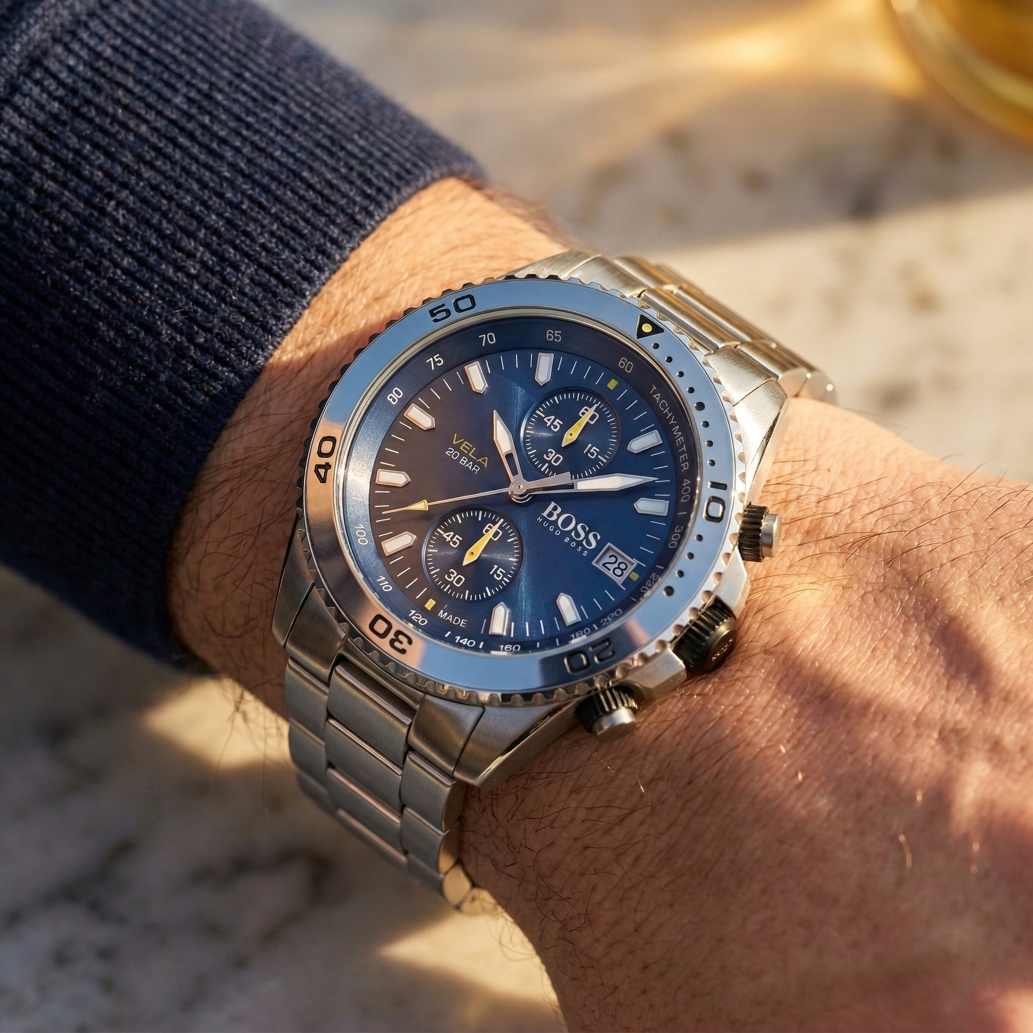 Close up of Hugo Boss Vela 1513775 on wrist showing blue dial and silver metal link strap with 50m water resistance