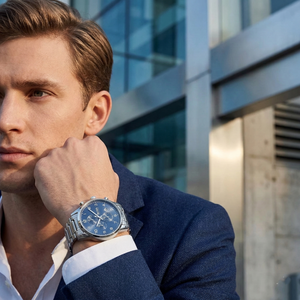 Professional man wearing Hugo Boss Skymaster 1513784 with blue dial and silver metal link strap water resistant 50m