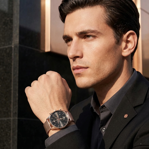 Professional man wearing Hugo Boss Associate 1513806 with black dial and rose gold metal mesh strap water resistant 50m