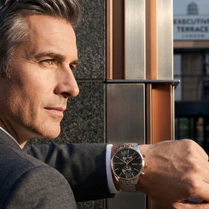 Professional man wearing Hugo Boss Associate 1513840 with black dial and silver rose gold metal strap water resistant 50m