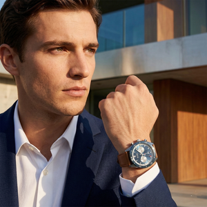 Professional man wearing Hugo Boss Santiago 1513860 with blue dial and brown leather strap water resistant 50m