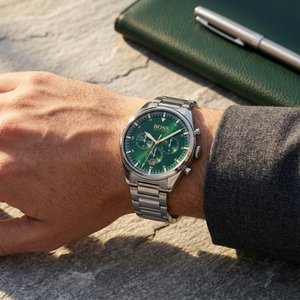Close up of Hugo Boss Pioneer 1513868 on wrist showing green dial and silver metal link strap with 50m water resistance