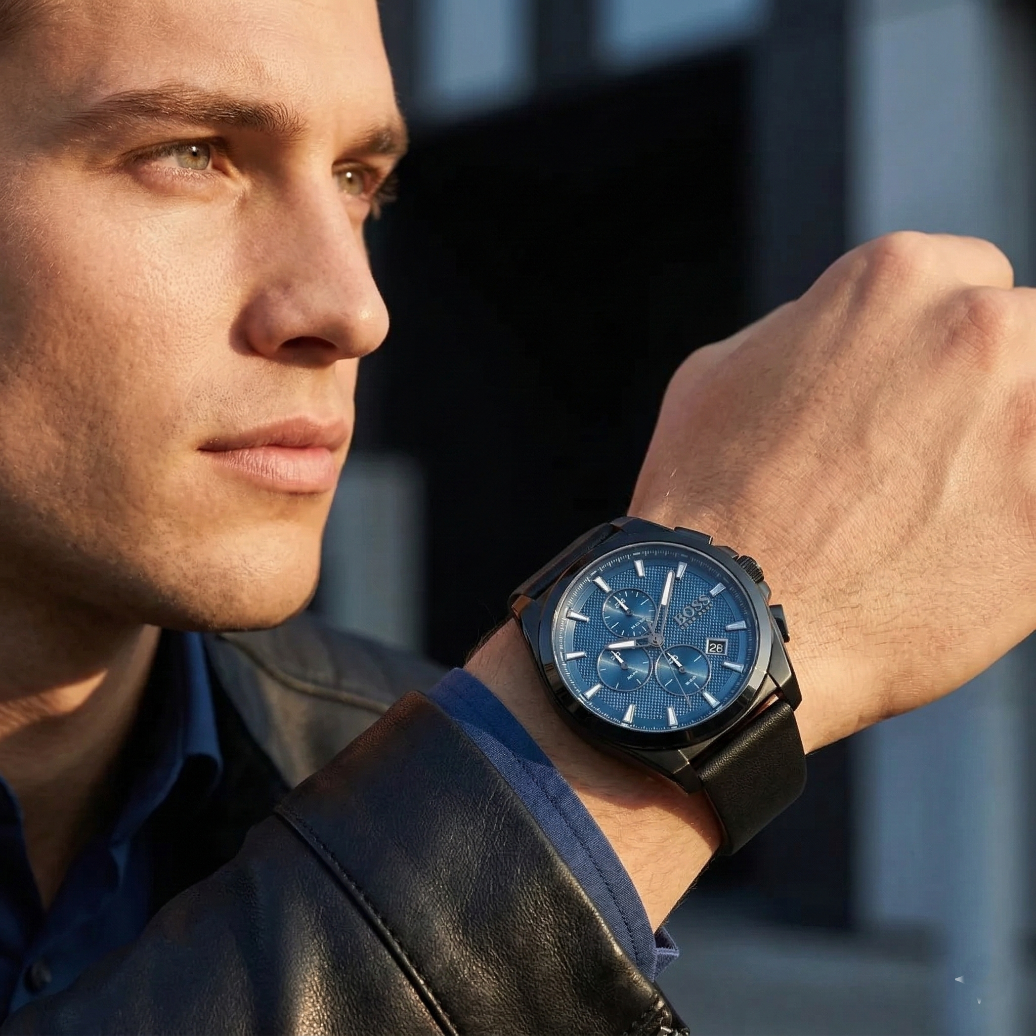 Professional man wearing Hugo Boss Grandmaster 1513883 with blue textured dial and black case leather strap water resistant 50m