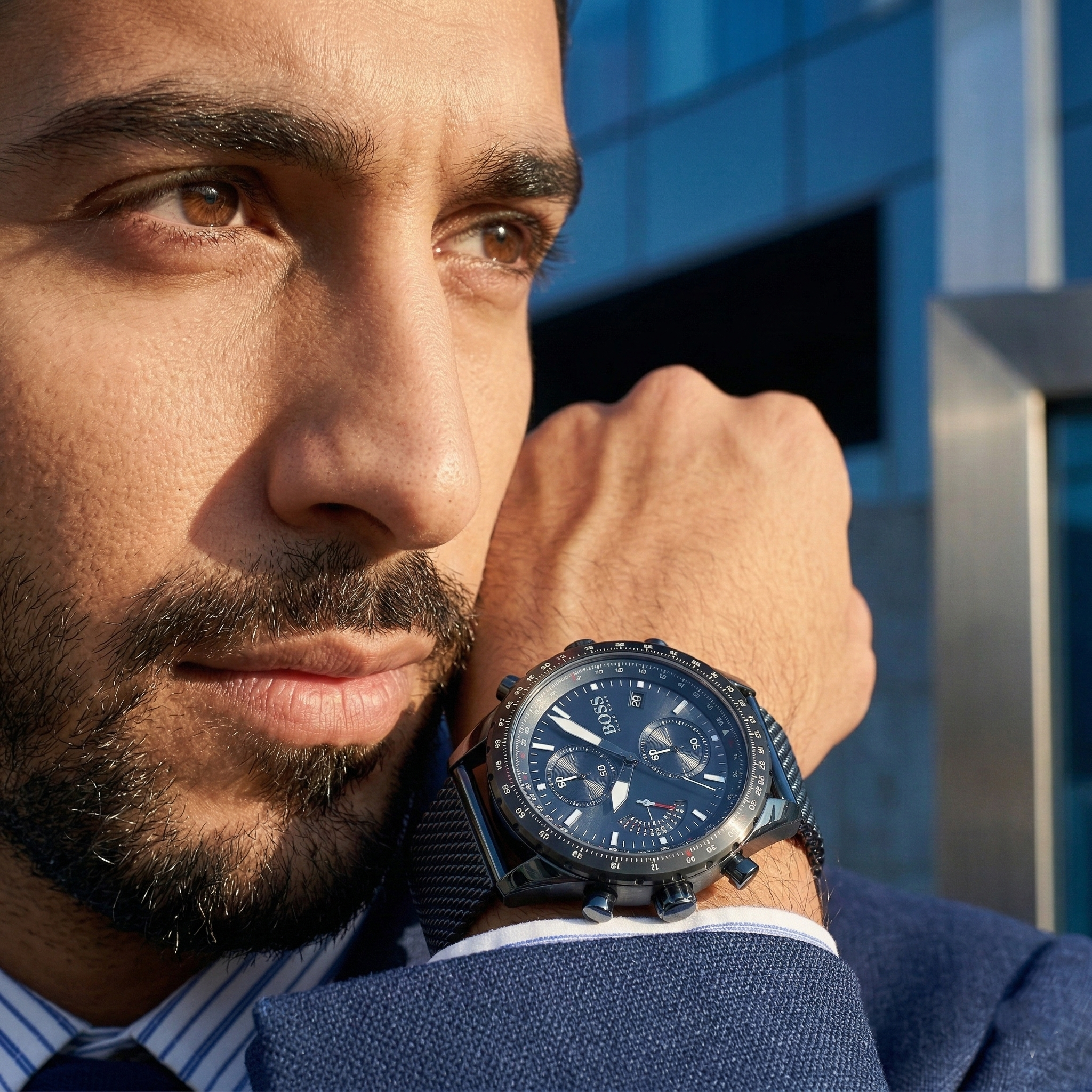 Professional man wearing Hugo Boss Pilot Edition 1513887 with blue dial and blue metal mesh strap water resistant 50m