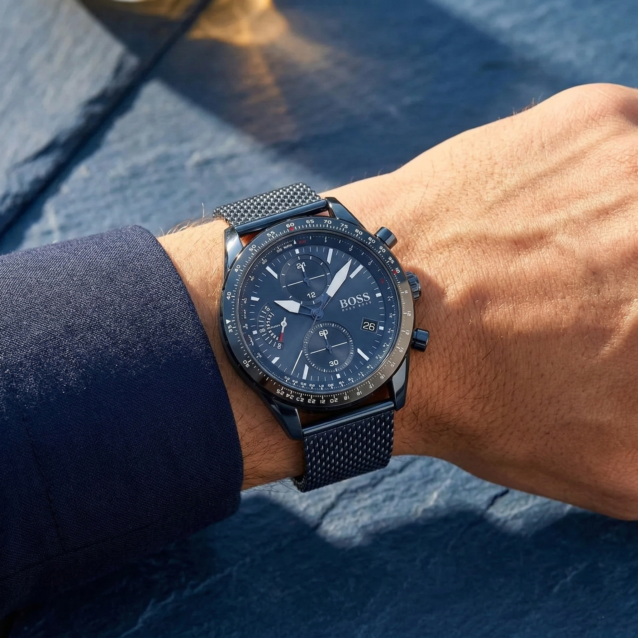 Close up of Hugo Boss Pilot Edition 1513887 on wrist showing blue dial and blue metal mesh strap with 50m water resistance