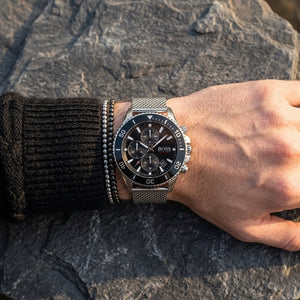 Close up of Hugo Boss Admiral 1513904 men's quartz battery watch on wrist showing black dial and luxury silver markers