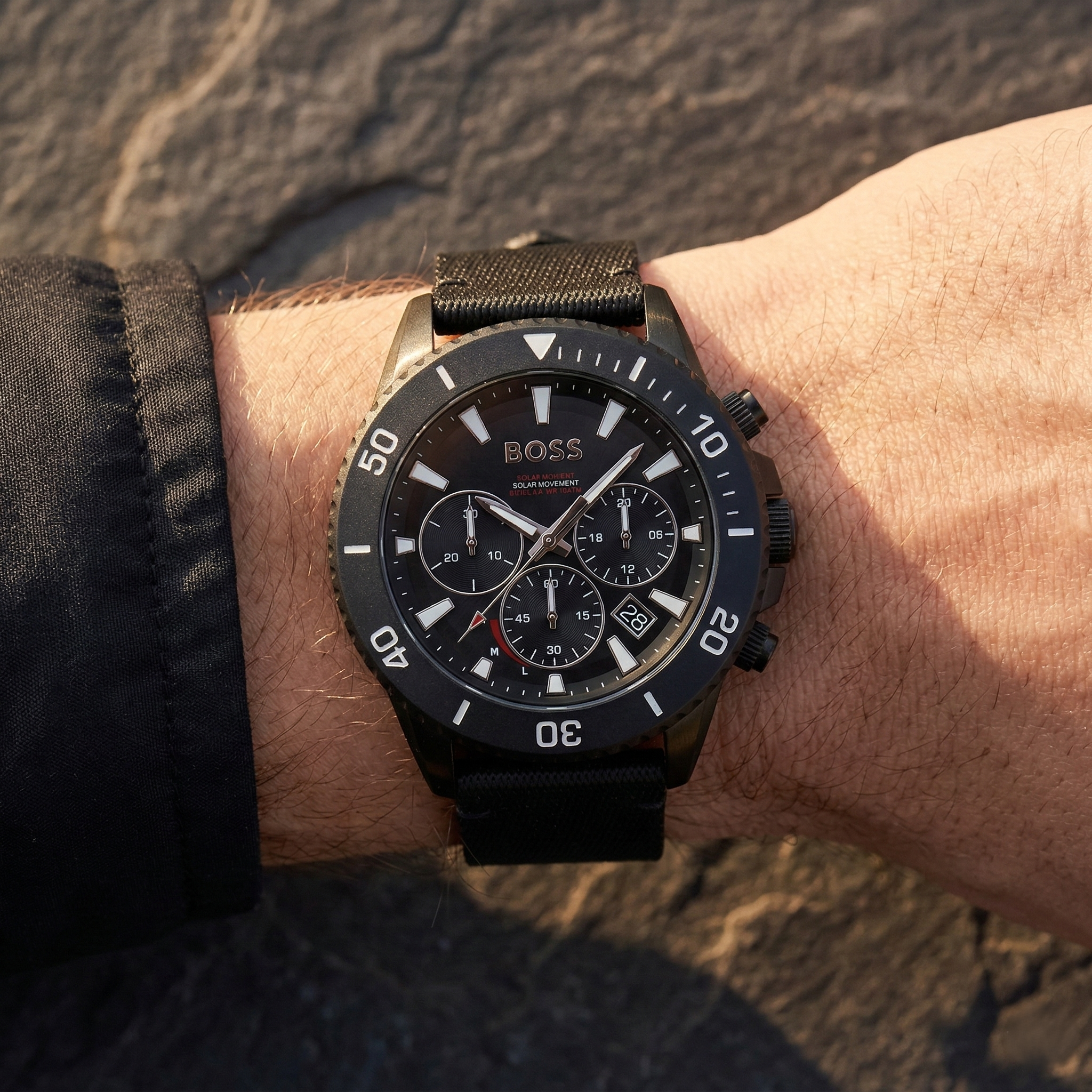 Close up of Hugo Boss Admiral 1513918 solar watch on wrist showing black dial and fiber strap with 50m water resistance