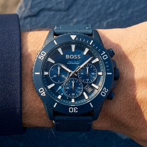Close up of Hugo Boss Admiral 1513919 solar watch on wrist showing blue dial and fiber strap with 50m water resistance