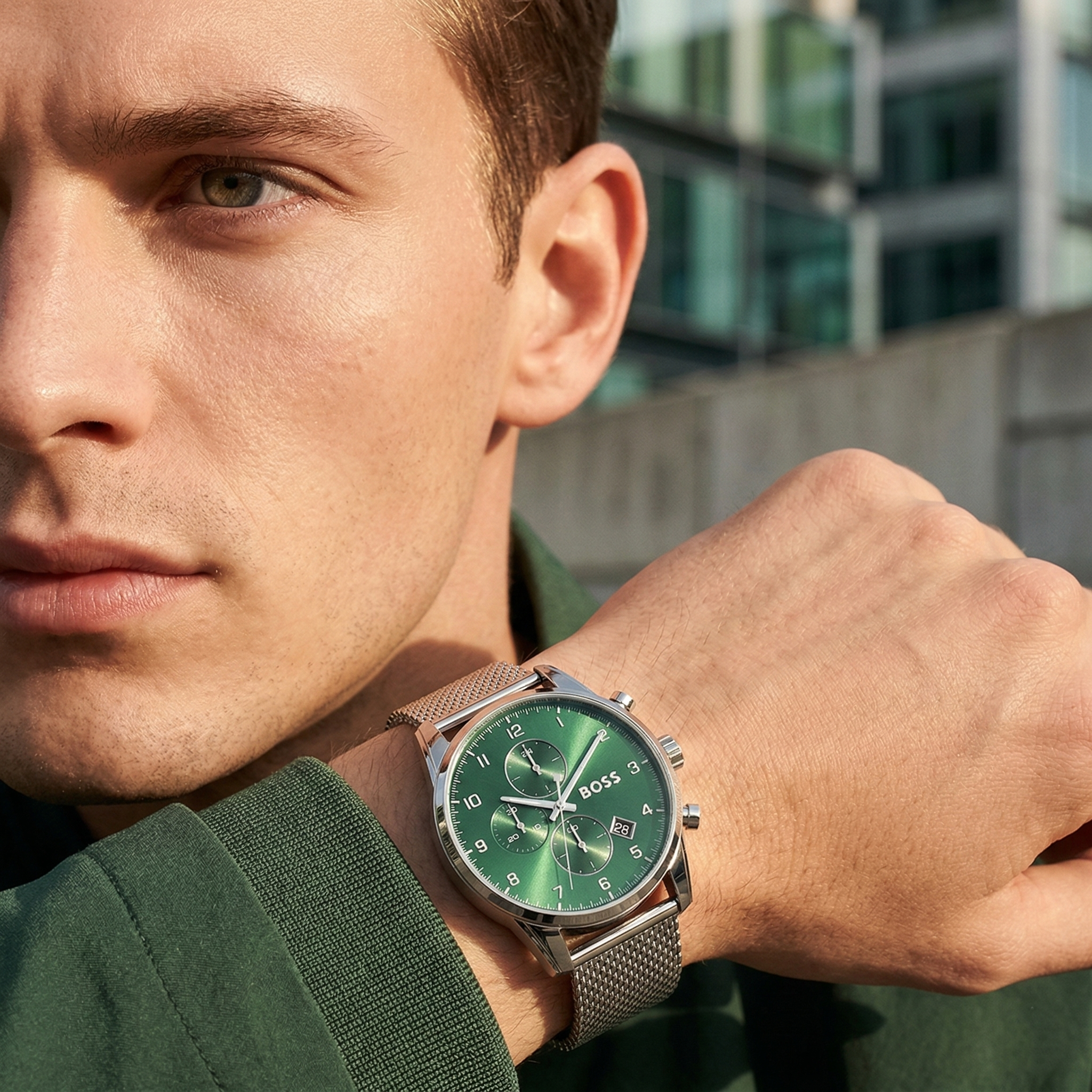 Professional man wearing Hugo Boss Skymaster 1513938 with green dial and silver metal mesh strap water resistant 50m