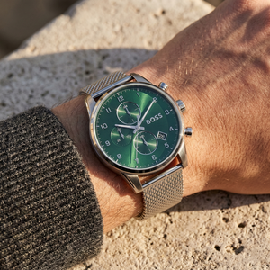 Close up of Hugo Boss Skymaster 1513938 on wrist showing green dial and silver metal mesh strap with 50m water resistance