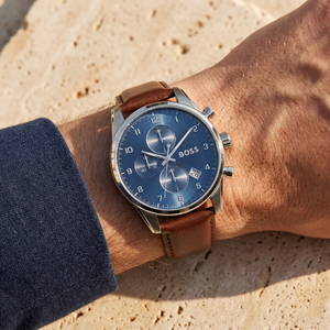 Close up of Hugo Boss Skymaster 1513940 on wrist showing blue dial and brown leather strap with 50m water resistance