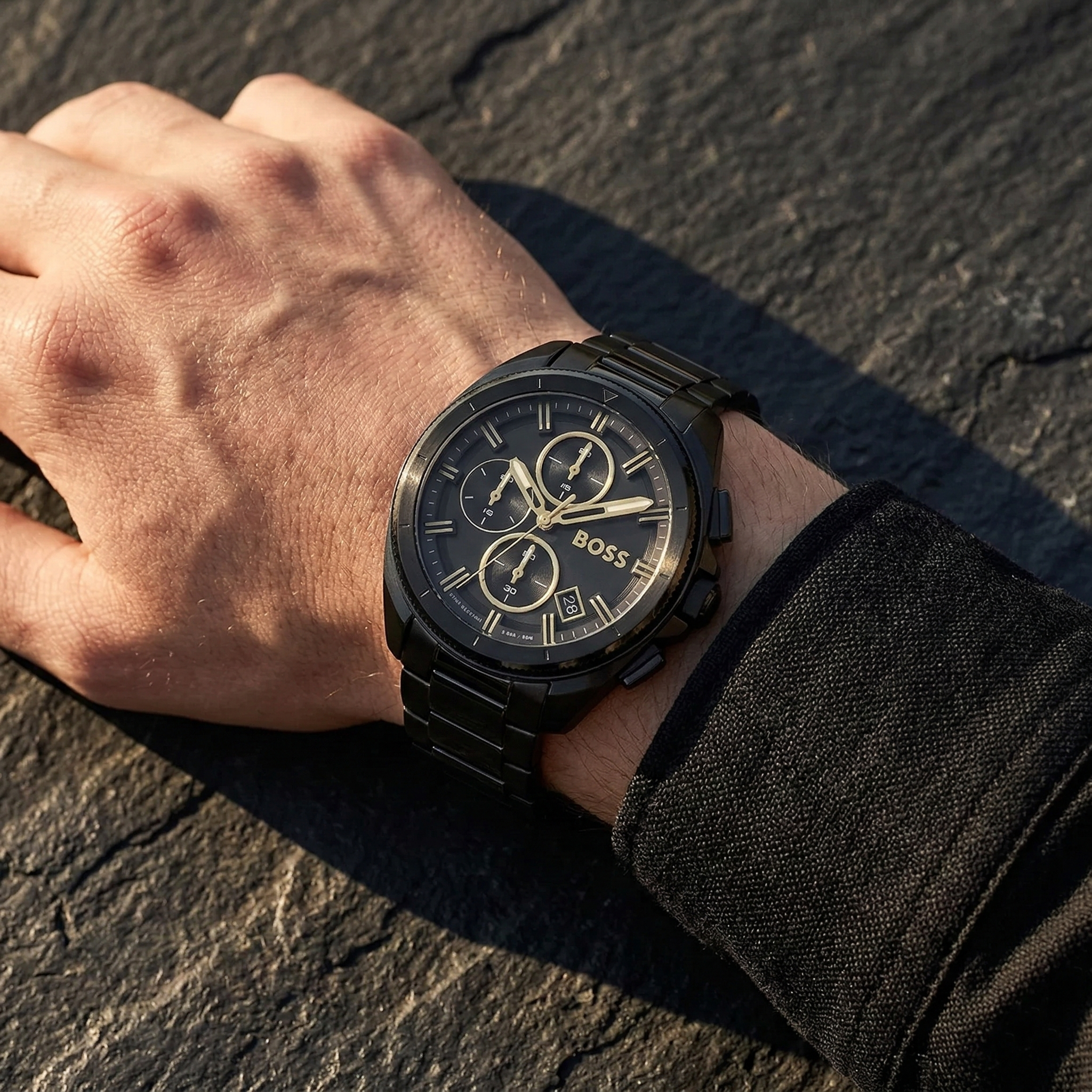 Close up of Hugo Boss Volane 1513950 on wrist showing black dial and black metal link strap with 50m water resistance