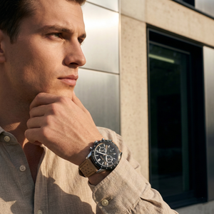 Professional man wearing Hugo Boss Allure 1513964 with black dial and black case beige leather strap water resistant 50m