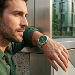 Professional man wearing Hugo Boss Associate Runner 1513975 with green dial and silver metal strap water resistant 50m