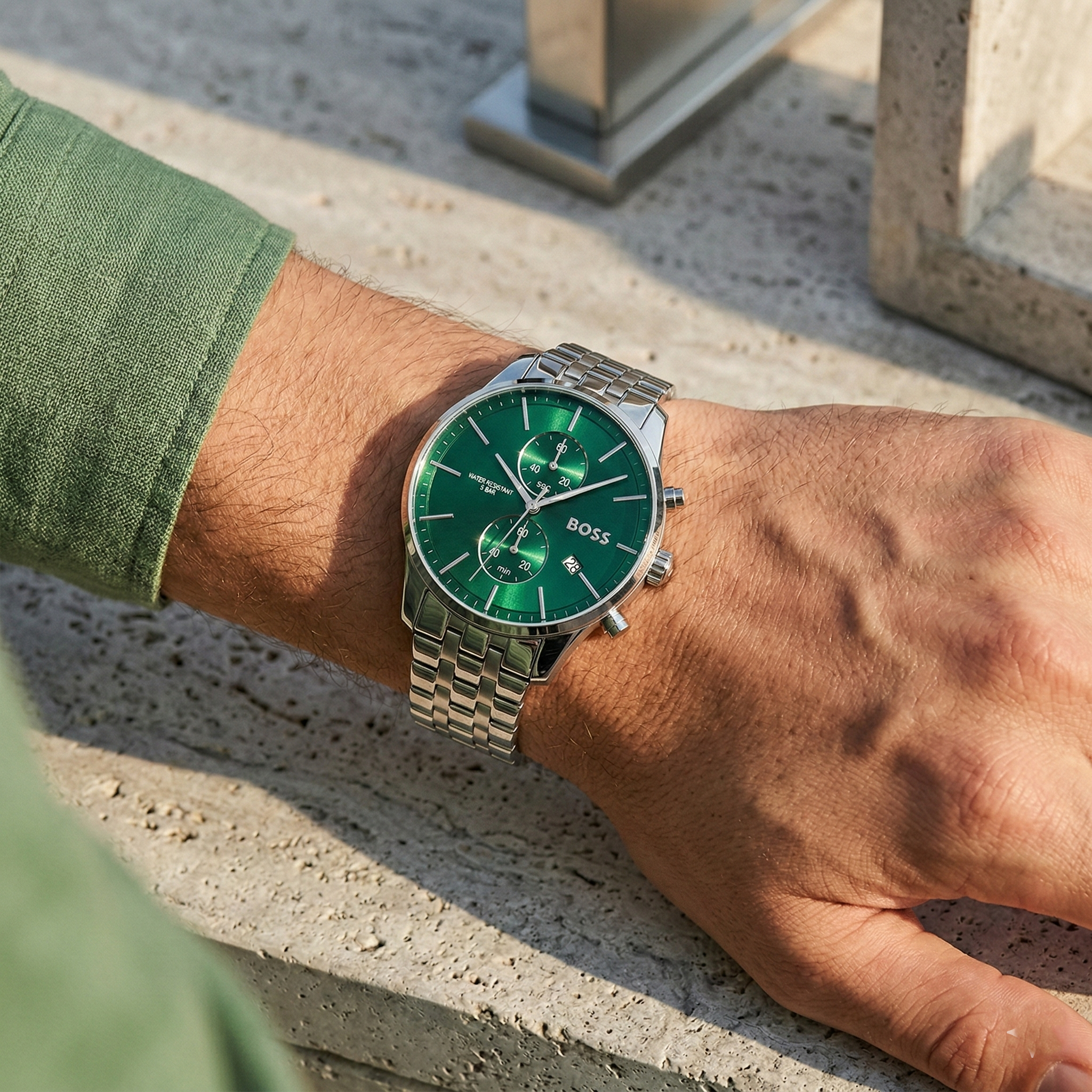 Close up of Hugo Boss Associate Runner 1513975 on wrist showing green dial and silver metal strap with 50m water resistance