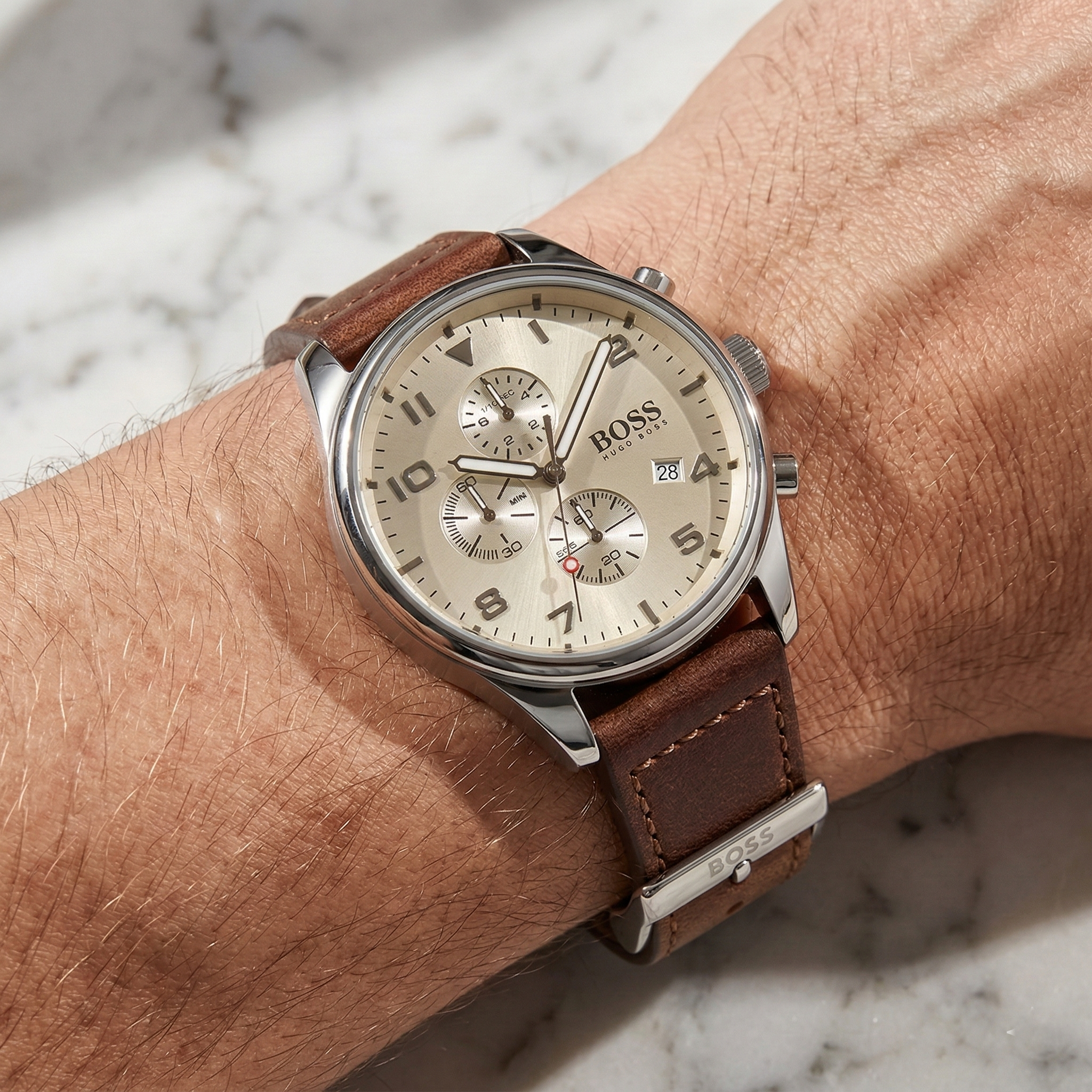 Close up of Hugo Boss View 1513990 on wrist showing beige dial and brown leather strap with 50m water resistance