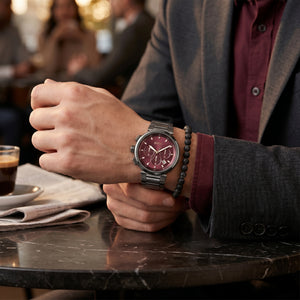 Lifestyle photo of Boss One 1514000 showing the bold gunmetal and red watch on a man's wrist in a professional setting from Luxury Hub Store