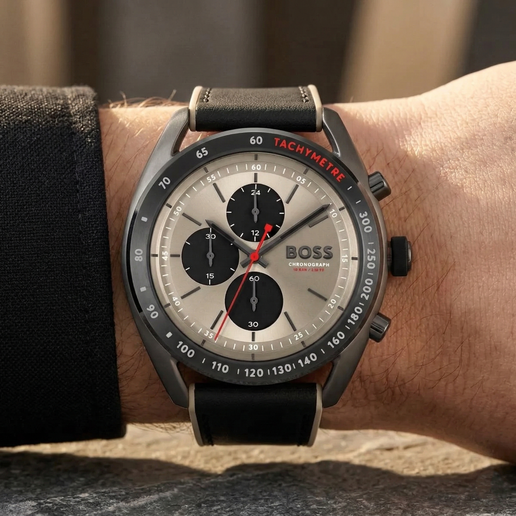 Close up of Hugo Boss Centre Court 1514024 on wrist showing champagne dial and black rubber strap with beige edges 100m water resistance