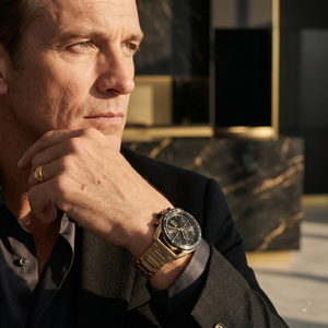 Professional man wearing Hugo Boss Centre Court 1514027 with black dial and gold metal strap watch water resistant 50m