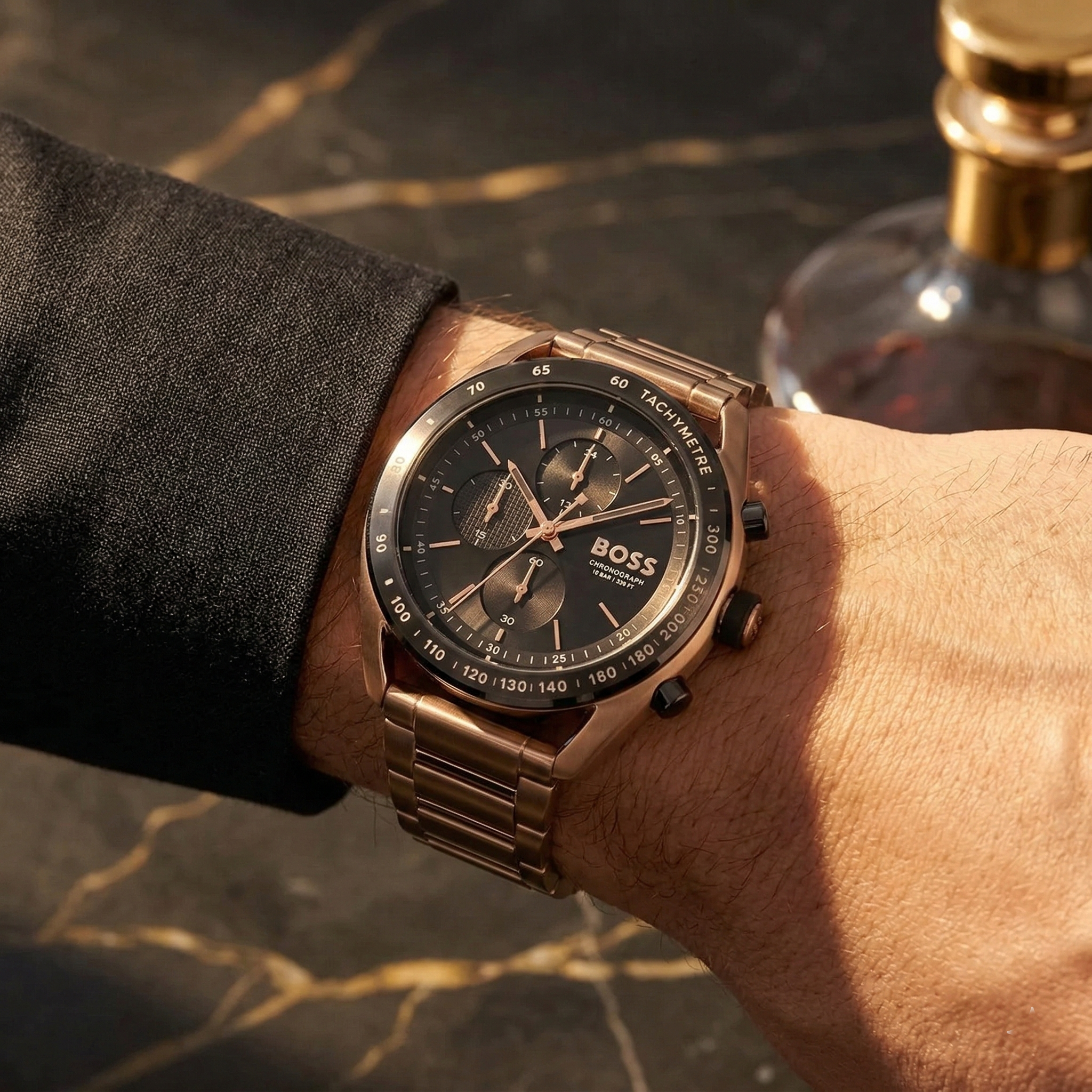 Close up of Hugo Boss Centre Court 1514027 on wrist showing black dial and gold metal strap with 50m water resistance