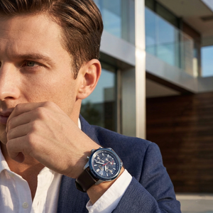 Professional man wearing Hugo Boss Solgrade 1514030 solar-powered watch with blue dial and brown leather strap 50m water resistant