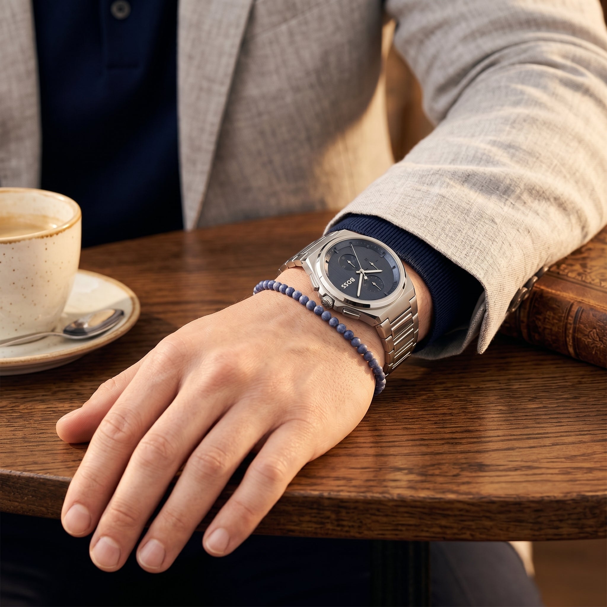 Close up shot of Boss Steer 1514048 on wrist showing the sleek integrated silver case and blue sunray dial from Luxury Hub Store