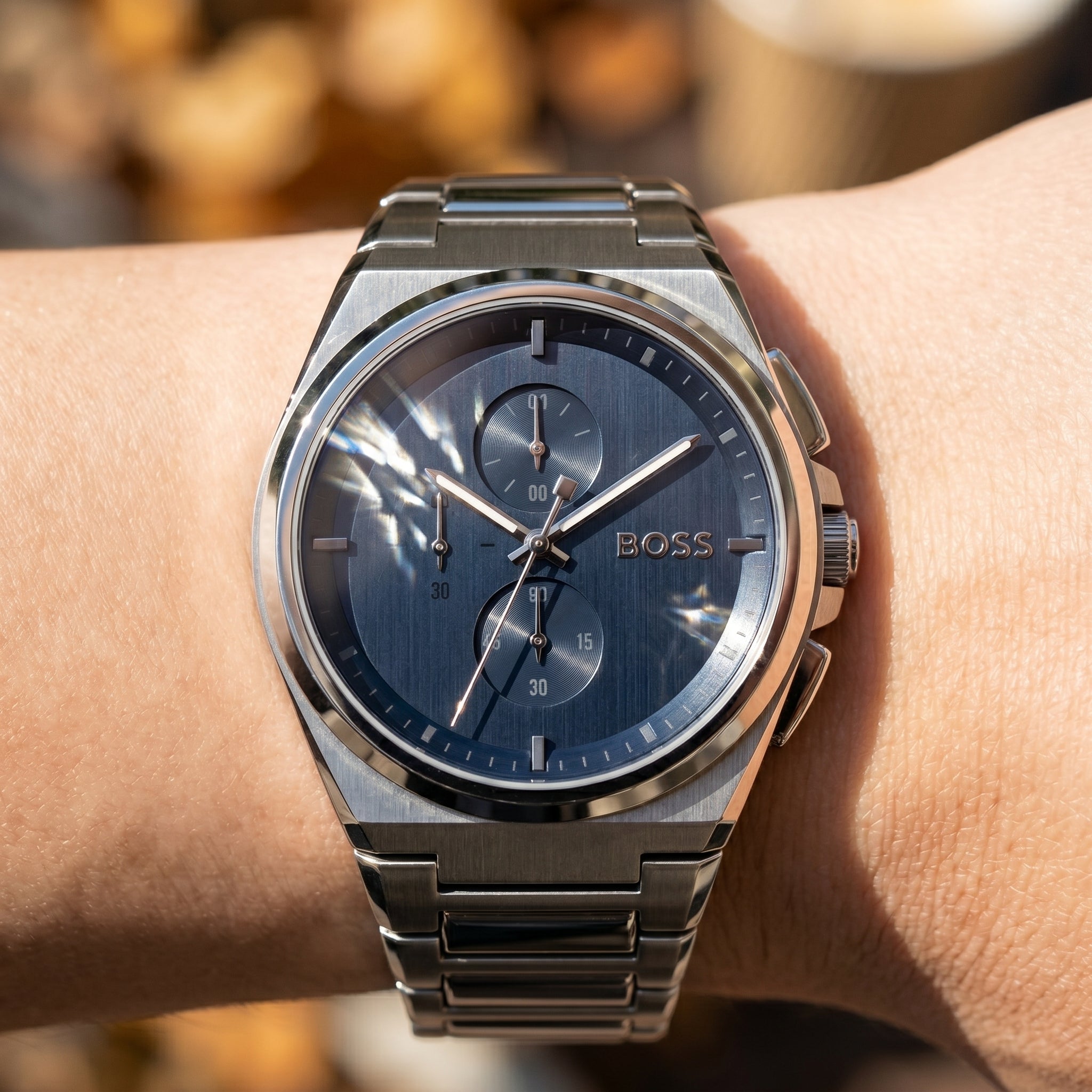Close up shot of Boss Steer 1514048 on wrist showing the sleek integrated silver case and blue sunray dial from Luxury Hub Store
