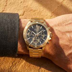 Close up of Hugo Boss Runner 1514059 on wrist showing gray dial and gold metal strap with 50m water resistance