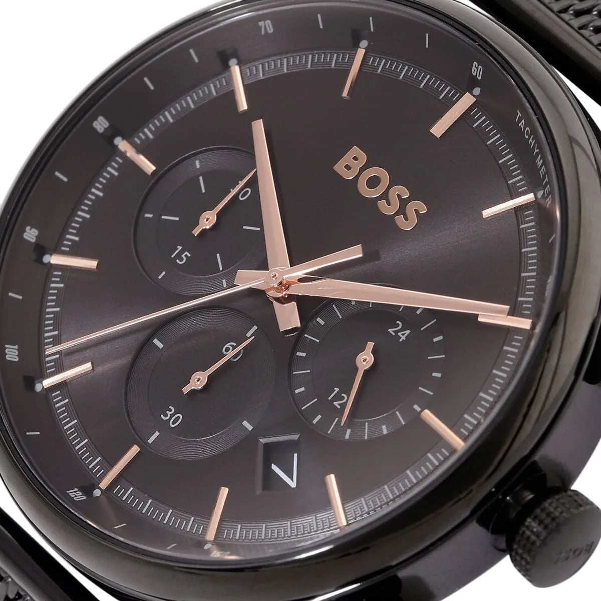 Close-up of a BOSS watch with a dark face and rose gold accents.