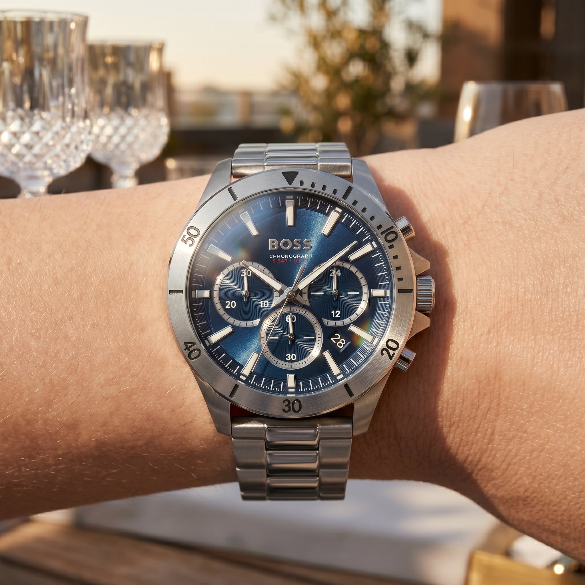 Close up shot of Boss Troper 1514069 on wrist showing the sporty silver case and detailed blue dial from Luxury Hub Store