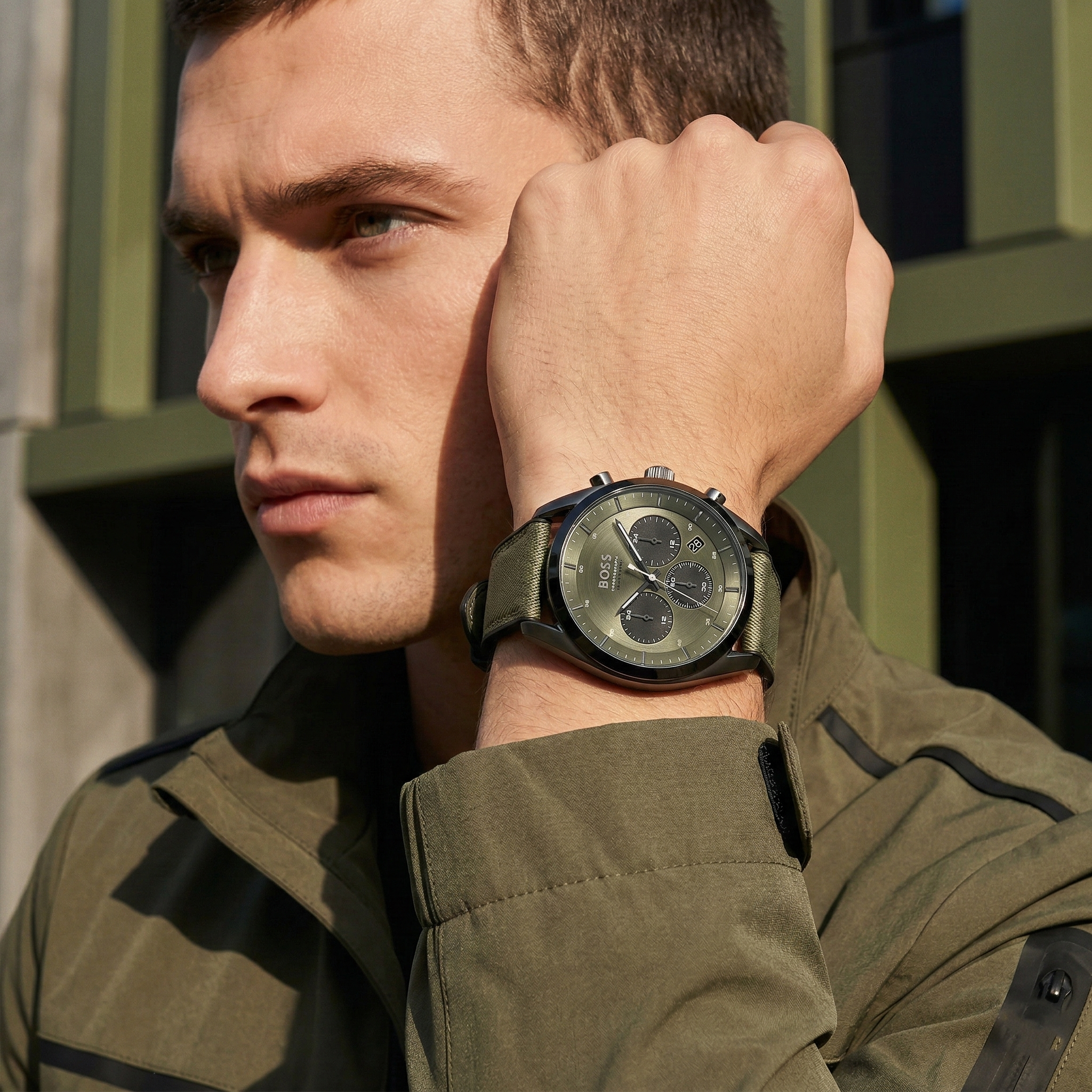 Professional man wearing Hugo Boss Top 1514092 with olive green dial and grey case canvas strap water resistant 100m