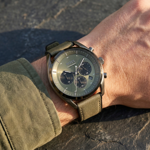 Close up of Hugo Boss Top 1514092 on wrist showing olive green dial and canvas strap with 100m water resistance