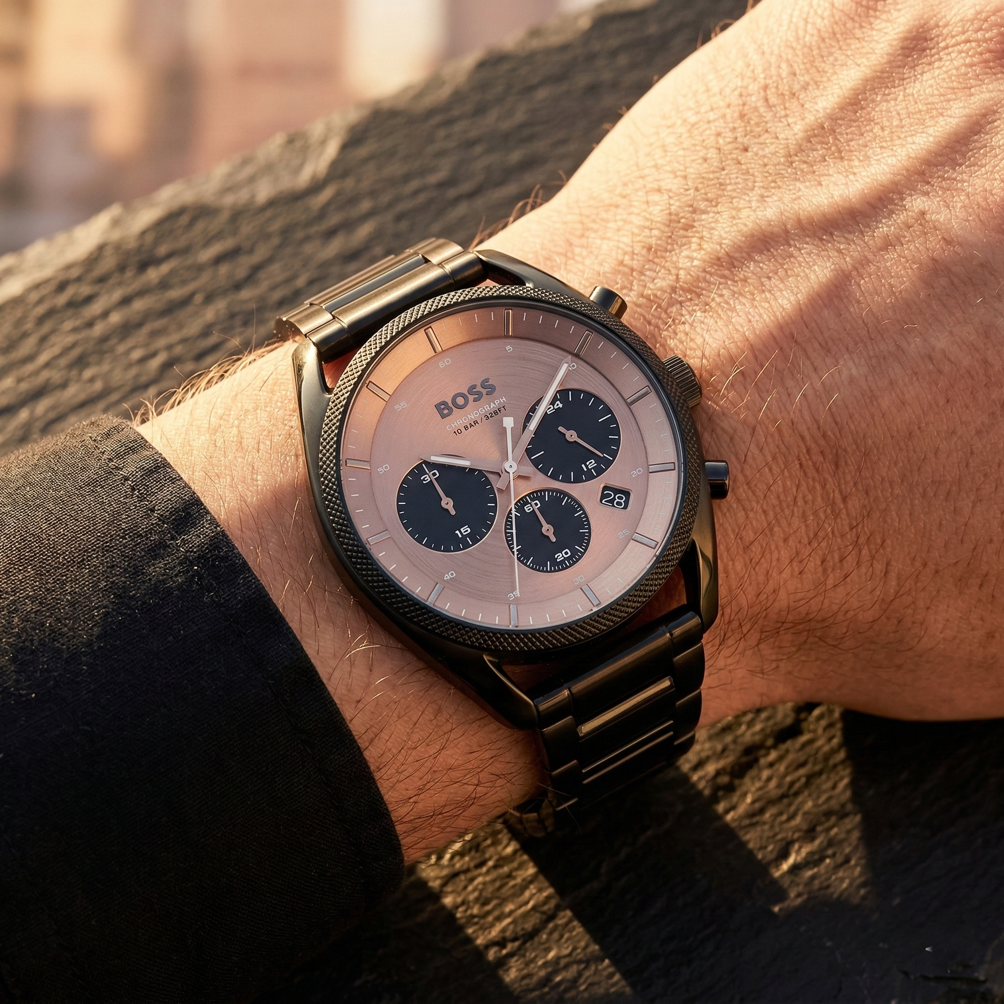 Close up of Hugo Boss Top 1514095 on wrist showing rose gold sunray dial and black metal strap with 100m water resistance