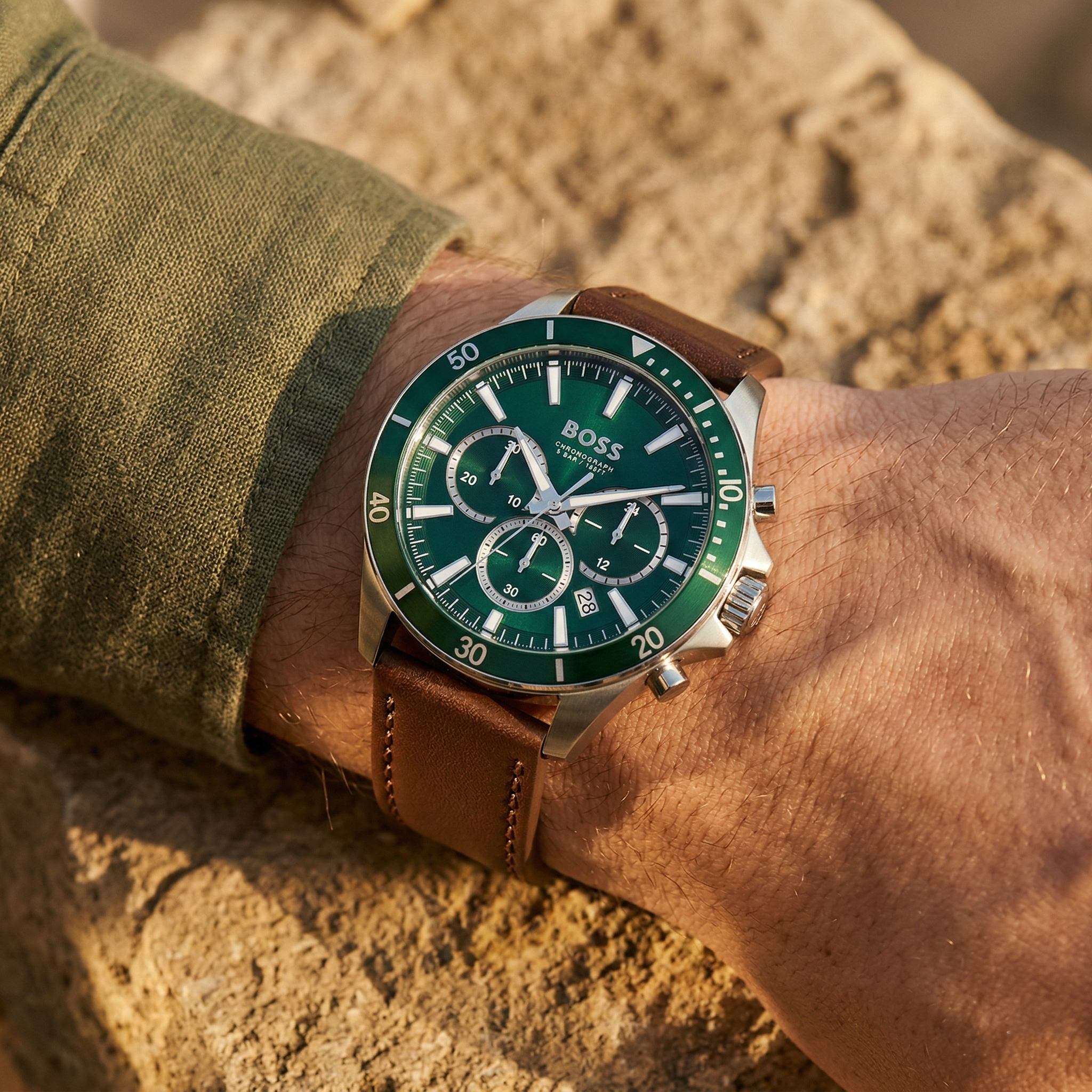 Close up of Hugo Boss Troper 1514098 on wrist showing green dial and silver case with 50m water resistance