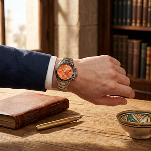 Lifestyle photo of Boss Runner 1514162 showing the bold silver and orange watch on a man's wrist in a dynamic setting from Luxury Hub Store