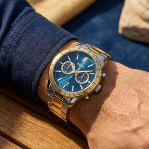 Close up of Hugo Boss Runner 1514163 on wrist showing blue dial and two-tone metal strap with 50m water resistance