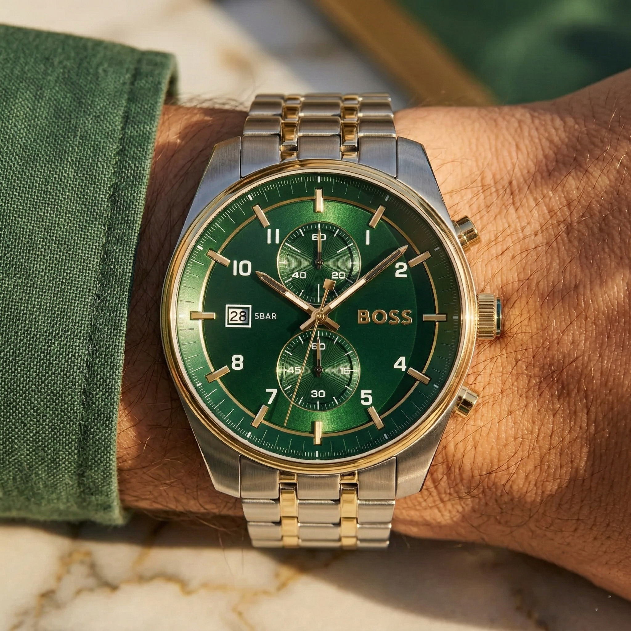 Close up of Hugo Boss Sky Traveller 1514195 on wrist showing green dial and silver gold case with 50m water resistance