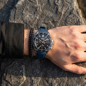 Close up shot of Hugo Boss 1514245 on wrist showing black and blue bezel and silver-tone case