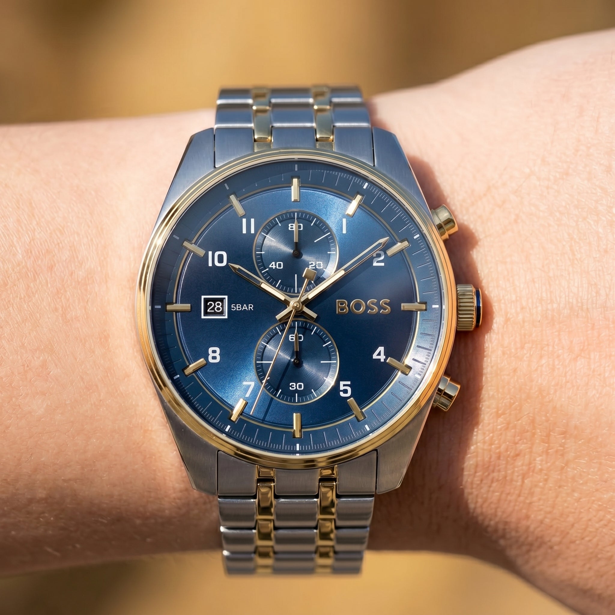 Close up shot of Boss Skytraveller 1514247 on wrist showing the sleek two-tone case and blue sunray dial from Luxury Hub Store