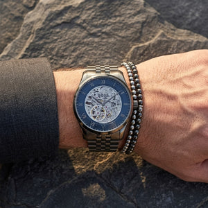 Close up shot of Hugo Boss 1514254 on wrist showing the transparent mechanical movement and blue dial
