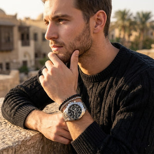 Elegant man wearing Hugo Boss Hero 1514267 men's quartz battery watch with silver case and luxury racing black dial