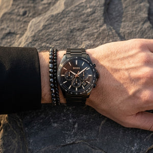 Close up shot of Hugo Boss 1514291 on wrist showing black textured dial and gold-tone hands