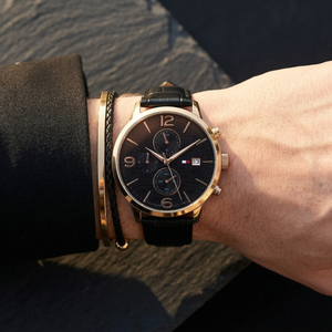 Close up of Tommy Hilfiger Liam 1710358 men's quartz battery watch on wrist showing black textured dial and black leather strap