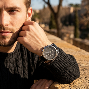 Elegant man wearing Tommy Hilfiger Liam 1710361 men's quartz battery watch with silver-tone case and luxury gray dial