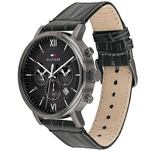 Angled profile right view of Tommy Hilfiger Evan Men's 1710395 watch showing polished round silver stainless steel case plain smooth bezel protective crown detailed integrated protected area and textured rich black genuine calfskin leather strap with white contrast stitching dynamic visually casual utility visual dynamic visual style visual dynamic visual utility dynamic casual utility